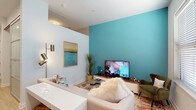 Located at 1341 Norton Ave in Columbus, Ohio's Grandview Heights neighborhood, this single-floor residence showcases a clean, contemporary design throughout. Light wood-tone flooring flows seamlessly across all rooms, lending warmth and visual continuity to the space.

The living area is a standout, anchored by a bold teal accent wall that adds a pop of color against the otherwise neutral palette. The room comfortably accommodates a sectional sofa and entertainment setup, creating an inviting atmosphere for relaxing or hosting guests.

The kitchen is thoughtfully designed with medium-toned wood cabinetry, stainless steel appliances including a range, microwave, dishwasher, and refrigerator, complemented by light quartz countertops and a geometric patterned tile backsplash. The layout maximizes efficiency while maintaining a stylish aesthetic.

The bedroom offers a tranquil retreat, featuring a sliding frosted-glass closet door and a high clerestory window that allows natural light to filter in while maintaining privacy.

The bathroom is finished with floor-to-ceiling white subway tile in the walk-in shower, a wood-vanity with quartz countertop, and light flooring that ties the space together cohesively.

A well-proportioned entryway hallway with a large mirror and closet completes this thoughtfully designed, modern residence.