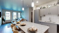 Located at 955 W Clairemont Ave in Eau Claire, Wisconsin, this well-appointed single-floor home offers four bedrooms, two bathrooms, and a thoughtfully designed open-concept layout. The kitchen serves as a central highlight, featuring sleek gray cabinetry, a white subway tile backsplash, granite countertops, black appliances, and a large island with pendant lighting and bar seating — ideal for both cooking and casual dining. The kitchen flows seamlessly into the living room, which is brightened by multiple windows offering views of the outdoors and features durable wood-style flooring. The primary bedroom provides a comfortable retreat with warm neutral tones and wood-style flooring. Additional bedrooms are well-sized, each with dedicated closet space, including a spacious walk-in closet. The bathrooms are finished with granite-topped vanities, wood-style flooring, and clean, modern fixtures including a walk-in shower. Two closets provide generous storage throughout the home. A connecting hallway ties all rooms together efficiently. The consistent use of neutral tones, modern finishes, and wood-style flooring throughout the home creates a cohesive, contemporary aesthetic well-suited for everyday living.