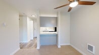 Located at 15723 40th Avenue West in Lynnwood, WA, this well-appointed one-bedroom, one-bathroom unit offers a thoughtfully organized single-floor layout. The combined kitchen and living area anchors the space, with a pass-through countertop in a marble-look finish visually connecting the two zones while maintaining a sense of openness. The kitchen features gray shaker-style cabinetry with ample storage, marble-look countertops, a stainless steel sink, and black appliances including an electric range and refrigerator, complemented by wood-look flooring for easy maintenance. The living area is finished with plush carpet and includes a ceiling fan with integrated lighting, contributing to a comfortable, functional environment. A sliding glass door brings in natural light and provides outdoor access. The bedroom is a well-proportioned retreat with carpet flooring, a window with a view of surrounding greenery, and neutral walls that offer a calm ambiance. A dedicated closet adds practical storage. The full bathroom is clean and modern, featuring a tub-shower combination, a vanity with a marble-look countertop, updated brushed-nickel fixtures, and wood-look flooring. The overall design emphasizes clean lines, neutral tones, and efficient use of space throughout.