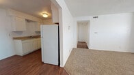 Located at 4215 SE 53rd St in Oklahoma City, Oklahoma, this single-floor residence offers a straightforward and functional layout designed for comfortable everyday living. The kitchen is equipped with white cabinetry, a double-basin sink, a dishwasher, a full-size refrigerator, and laminate countertops, all set atop durable hardwood-style flooring. The kitchen opens toward the living areas, creating an efficient flow throughout the home. The living room is a generously sized, open space featuring warm, neutral carpet, a textured ceiling, and a window that allows natural light to fill the room. A central hallway connects the main living areas to the private spaces of the home. The bedrooms are each well-proportioned, finished with the same neutral carpet and textured ceilings, and each room features a window with blinds for natural light and privacy. The bathroom includes a full-size soaking tub and shower combination with clean white tile surround and chrome fixtures. Throughout the home, white walls and neutral finishes provide a clean, move-in-ready canvas. The single-floor layout ensures convenient accessibility, making this residence a practical and comfortable option in the southeast Oklahoma City area.