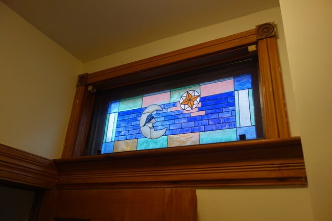 Unique stained glass window in hallway. - 216 Kentucky