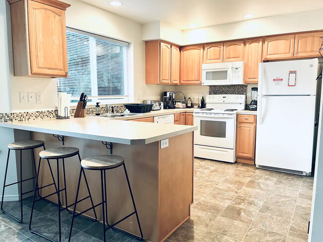 Full kitchen with lots of cabinet space and full size pantry - 210 SW Moorea Ln