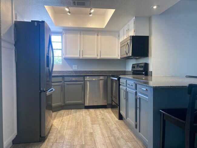 Kitchen with dishwasher, fridge, stove/oven and microwave - 5950 N 78th St