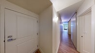 Located at 201 Yesler Way in Seattle's historic Pioneer Square neighborhood, this one-bedroom, one-bathroom unit offers an efficient and well-organized layout across a single floor. Warm hardwood-style flooring runs throughout the space, providing a consistent and inviting aesthetic from room to room.

The entry hallway sets a clean, minimal tone, with white walls and wall-mounted lighting that guide you through the unit. The kitchen is thoughtfully arranged with dark countertops contrasting white cabinetry that extends to the ceiling, maximizing storage. It is equipped with a full-size refrigerator, an electric range, and a stainless steel sink, with a window that brings in natural light and views of the street outside.

The bedroom is a cozy and functional space featuring clean white walls, hardwood-style floors, and a sliding closet with built-in shelving and a hanging rod, providing practical storage solutions. An additional panel door within the bedroom offers further organizational flexibility.

The bathroom is straightforward and clean, featuring a full-size soaking tub with a shower, fitted with chrome fixtures and a classic white surround. The overall ambiance of the unit is clean, neutral, and move-in ready, making it a practical option in the heart of downtown Seattle.