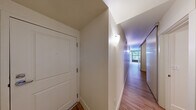 Located at 201 Yesler Way in Seattle's historic Pioneer Square neighborhood, this one-bedroom, one-bathroom unit offers an efficient and well-organized layout across a single floor. Warm hardwood-style flooring runs throughout the space, providing a consistent and inviting aesthetic from room to room.

The entry hallway sets a clean, minimal tone, with white walls and wall-mounted lighting that guide you through the unit. The kitchen is thoughtfully arranged with dark countertops contrasting white cabinetry that extends to the ceiling, maximizing storage. It is equipped with a full-size refrigerator, an electric range, and a stainless steel sink, with a window that brings in natural light and views of the street outside.

The bedroom is a cozy and functional space featuring clean white walls, hardwood-style floors, and a sliding closet with built-in shelving and a hanging rod, providing practical storage solutions. An additional panel door within the bedroom offers further organizational flexibility.

The bathroom is straightforward and clean, featuring a full-size soaking tub with a shower, fitted with chrome fixtures and a classic white surround. The overall ambiance of the unit is clean, neutral, and move-in ready, making it a practical option in the heart of downtown Seattle.