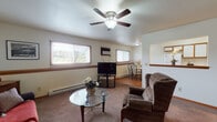 Located at 311 Barberry Ct in DeKalb, Illinois, this single-floor residence offers a well-organized layout designed for comfortable everyday living. The living room serves as the heart of the home, featuring plush carpeting, a ceiling fan with light fixture, baseboard heating, and multiple windows fitted with blinds that bring in ample natural light. The space comfortably accommodates seating and entertainment areas, creating a welcoming atmosphere.

Adjacent to the living room is a compact dining nook with hardwood-style flooring, a window overlooking the surroundings, and baseboard heating — ideal for casual meals. The kitchen is efficiently designed with wood-trimmed white cabinetry, a full suite of appliances including a refrigerator and range, a stainless steel sink, and hardwood-style flooring that ties the space together cohesively.

The two bedrooms are carpeted and each include a ceiling fan, windows with views of the neighborhood, and baseboard heating. One bedroom features a walk-in closet, providing generous storage. The full bathroom offers a vanity with wood cabinetry, a tub-shower combination, tile flooring, and warm wood-toned accents throughout. Overall, the residence presents a functional and cozy living environment in a quiet DeKalb neighborhood.