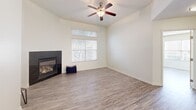 This 930 square foot single-story residence in Bakersfield, CA offers a well-designed living space with 2 bedrooms and 2 bathrooms. The home features a modern kitchen with honey-colored wood cabinetry, black countertops, and stainless steel appliances. A breakfast bar provides additional seating and separates the kitchen from the living area.

The living room is spacious and bright, featuring a gas fireplace and large windows that allow natural light to flood the space. Throughout the home, neutral-toned walls and grey wood-look flooring create a contemporary ambiance. Ceiling fans in the bedrooms and living areas provide comfort and air circulation.

Both bathrooms are well-appointed, with one featuring a combination tub/shower and the other a standalone shower. The primary bedroom, measuring 170 square feet, offers ample space and includes a closet with built-in organizers.

Additional amenities include an attached garage with an automatic door opener, providing secure parking and storage. The property's layout is efficient, with a hallway connecting the various rooms. Overall, this home presents a modern, low-maintenance living option with updated features and a neutral palette ready for personalization.