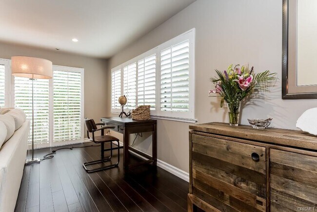 Living room with plantation shutters on sliding doors and windows - 4455 Fulton Ave