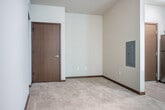 Located at 5414 Mineral Point Rd in Madison, Wisconsin, this efficiently designed studio unit makes smart use of its compact footprint across a single floor. The open living area features warm neutral-toned walls, plush carpet, and light hardwood-style flooring that transitions seamlessly between spaces. A window fitted with blinds allows natural light to filter in, offering views of the surrounding greenery, while a private exterior door with a glass panel further connects the interior to the outdoors. A wall-mounted mini-split HVAC unit ensures personalized climate control throughout the space.

The kitchen is well-appointed with a full suite of stainless steel appliances, including a refrigerator, electric range with oven, over-the-range microwave, and dishwasher. Dark espresso-toned lower cabinetry is paired with crisp white upper cabinets, and the clean white countertops provide ample workspace. Light wood-look flooring extends throughout the kitchen, contributing to a cohesive, modern aesthetic.

The bathroom continues the contemporary design language, featuring a dark-toned vanity with a granite-style countertop and a large mirror above. A walk-in shower with a clean white surround and chrome fixtures completes the space, offering both functionality and style in a refined, understated package.