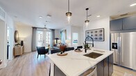 This thoughtfully designed 2-bedroom, 2-bathroom residence in Houston's 77055 corridor offers a seamless blend of modern finishes and functional living. The open-concept kitchen serves as the heart of the home, showcasing bold navy cabinetry with gold hardware, quartz countertops, a subway tile backsplash, stainless steel appliances, and a large center island with pendant lighting — ideal for both cooking and entertaining. The kitchen flows naturally into a bright living room, where light wood-style flooring, a ceiling fan, and French doors with access to the outdoors create an airy, welcoming atmosphere. The primary bedroom is a generous retreat featuring plush carpet, a ceiling fan, and a direct en suite bath appointed with a dual-sink vanity in navy blue, a backlit mirror, white quartz counters, and an elegant marble-style walk-in shower. The second bedroom is equally well-appointed, offering natural light through large windows and its own access to a full bath complete with marble-surround tub and shower. Dedicated closets provide ample storage throughout. Clean white walls and consistent premium finishes tie together the cohesive, contemporary aesthetic of this well-appointed Houston residence.