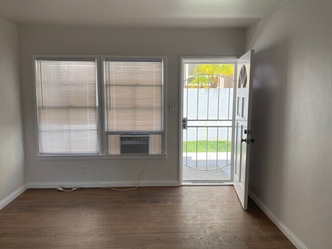 LIVING ROOM: New Hardwood Floor, Security Screen, Window A/C Unit (with remote control) - 507 E Harvard Rd
