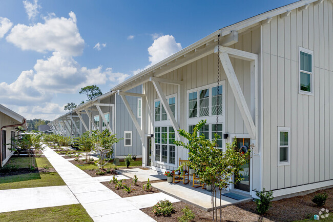 Sidewalk between buildings. - The Cottages at Myrtle Beach