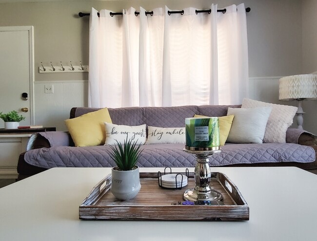 Spacious living space with lots of natural light, ceiling fan and a fireplace. - 10101 Hanover Dr