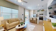 Located in Melissa, TX, this well-appointed 2-bedroom, 3-bathroom single-story home offers a bright and functional layout designed for comfortable living. Light wood-style flooring flows seamlessly throughout, tying the spaces together with a warm, cohesive aesthetic.

The welcoming entrance hallway leads directly into an open-concept living and kitchen area filled with natural light from large windows and a sliding glass door. The kitchen features gray shaker-style cabinetry, white quartz countertops, stainless steel appliances, a center island with bar seating, and a dedicated pantry. The adjoining living room is spacious and airy, highlighted by a ceiling fan and easy access to a private outdoor patio.

The primary bedroom is a serene retreat with a ceiling fan, a large window, and direct access to an en-suite bathroom. The primary bath showcases a dual-sink vanity with gray cabinetry, a glass-enclosed walk-in shower with tile surround, and a dedicated walk-in closet. The second bedroom is comfortably sized with its own ceiling fan, closet access, and a bright window. A convenient in-unit laundry area and three total closets round out the practical features of this home.