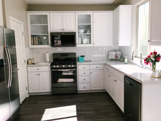 White kitchen with quartz countertops and modern GE appliances - 4845 Ballast Ln