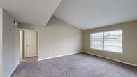Located at 601 W Renner Rd in Richardson, TX, this one-bedroom, one-bathroom residence offers a thoughtfully organized single-floor layout. The living room features vaulted ceilings with a textured finish, neutral-toned carpet, and a window with blinds that allows natural light to fill the space, creating an open and airy feel.

The kitchen is a standout feature, showcasing granite countertops, white cabinetry, stainless steel appliances including a refrigerator, electric range, and microwave, as well as a double-basin undermount sink. Stylish pendant lighting and a wood-accent backsplash detail add a modern touch. The kitchen opens to the living area via a peninsula counter, enhancing the flow between spaces.

The bedroom is carpeted and well-proportioned, featuring a window that brings in natural light. It includes access to a dedicated walk-in closet equipped with dual hanging rods on both sides, providing ample storage. The bathroom features a full tub-shower combination with tile surround and chrome fixtures.

Throughout the unit, neutral wall tones, white trim, and consistent carpet flooring create a clean and cohesive aesthetic. The overall layout is efficient and functional, making excellent use of the available floor area.