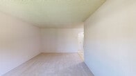 Located at 260 N Mathilda Ave in Sunnyvale, California, this single-floor residence offers four bedrooms, one bathroom, and two kitchens within a practical and functional layout connected by a central hallway. The bedrooms feature neutral-toned carpet flooring and textured ceilings, with the spacious primary bedroom providing generous room for furnishings. Several bedrooms include windows that let in natural light and offer views of surrounding greenery. The kitchens are equipped with wooden cabinetry, dark granite-style countertops, tile flooring, and baseboard heating. One kitchen includes a white electric range, an overhead exhaust hood, and a window overlooking the outdoors. The shared bathroom is finished with matching tile flooring, a granite-topped wooden vanity, a combined tub and shower with sliding glass doors, and a small window for natural ventilation. Outside, a private backyard enclosed by a wooden fence provides a quiet outdoor retreat, complete with a concrete pad and mature trees that offer shade and a natural backdrop. The overall aesthetic is clean and understated, offering a functional living environment in a well-established Sunnyvale neighborhood.