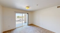 Located at 1420 North Ave in Corcoran, CA, this single-story, 3-bedroom, 2-bathroom unit offers a practical and comfortable layout designed to maximize everyday livability. The kitchen is a functional centerpiece, featuring warm oak-toned cabinetry with ample upper and lower storage, a white gas range with overhead ventilation, a double sink, and generous countertop space. Wood-style flooring runs throughout the kitchen and main living areas, providing a clean and cohesive look. A peninsula counter adds additional workspace and creates a natural transition between the kitchen and adjoining areas. The three bedrooms are carpeted and filled with natural light courtesy of large windows fitted with vertical blinds. Each room offers a calm, neutral palette with white walls and practical layouts suited for various furniture arrangements. Two closets provide dedicated storage within the unit. The two bathrooms are straightforward in design, each featuring a tub-shower combination, a vanity with under-sink cabinetry, and wood-style flooring. A connecting hallway ties the rooms together efficiently. Overall, the unit presents a clean, no-frills interior well-suited for comfortable everyday living.