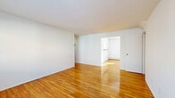 Located at 72 Woodbridge Ave in Highland Park, NJ, this well-appointed one-bedroom, one-bathroom residence offers a thoughtfully designed single-floor layout. Polished hardwood floors flow throughout the living, dining, and bedroom areas, lending warmth and continuity to the space. The open living and dining area is bright and inviting, featuring white walls that enhance the natural light streaming through large windows. A wall-mounted air conditioning unit and baseboard heating ensure year-round comfort. The kitchen is equipped with rich cherry wood cabinetry, dark granite-style countertops, a gas range, full-size refrigerator, and a double sink — all set on easy-care tile flooring. A convenient pass-through connects the kitchen to the dining area. The bedroom is generously sized, featuring two windows that fill the room with natural light, hardwood floors, and ample closet access — with three closets distributed throughout the unit. The bathroom is finished with classic white subway tile, a tiled tub-surround, a wood-vanity with countertop sink, and a window for ventilation. A hallway ties the layout together efficiently, making this a practical and comfortable Highland Park residence.