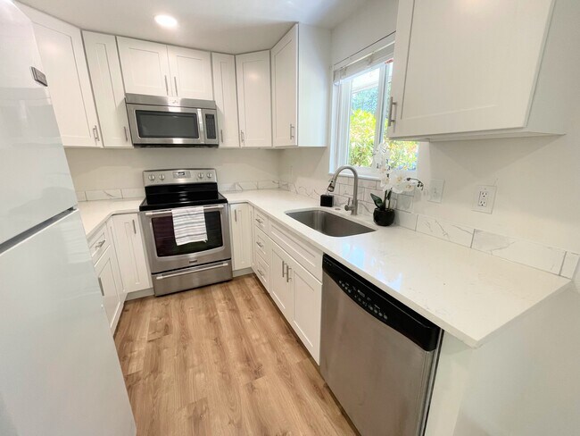 Updated kitchen with brand new kitchen cabinets and quartz counter top - 1608 Porter Way