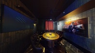 Jazz Hands Social Club is a thoughtfully designed, reservation-only social venue that seamlessly combines Art Deco aesthetics with a modern, upscale atmosphere. The space is unified by striking patterned wallpaper featuring repeating arch motifs in cool blues and grays, dark marble-veined tile flooring, and exposed industrial ceilings that add a raw, urban contrast to the refined décor throughout.

The main lounge area features a plush teal velvet sectional sofa accented with amber and neutral throw pillows, centered around a marble-topped pedestal table. Jazz-themed artwork adorns the walls, reinforcing the club's musical identity. Floor-to-ceiling windows flood the lounge with natural light and offer sweeping city skyline views, complemented by lush tropical greenery and warm-toned accent chairs.

A dedicated bar area is outfitted with sleek black barstools, pendant globe lighting, and a clean white counter surface, while a retro jukebox near the entrance adds a nostalgic touch. A wooden shuffleboard table provides interactive entertainment in a separate game area alongside moody wall sconces and curated artwork.

A private dining room anchors the space with a distinctive circular table topped in a warm gold finish, surrounded by tufted black leather chairs, deep red curtains, and cinematic wall-mounted displays — ideal for intimate gatherings. The venue's layered lighting, bold design choices, and eclectic furnishings create a sophisticated yet inviting environment for an elevated social experience.