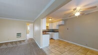 Located at 3335 Artesia Blvd in Torrance, California, this single-story residence offers a well-organized layout with distinct living, kitchen, and sleeping areas. The entry area features tile flooring and is brightened by multiple windows fitted with vertical blinds, allowing natural light to flow through the space. A ceiling fan is positioned overhead, adding both function and comfort.

The kitchen is defined by white shaker-style cabinetry, dark granite-look countertops, and tile flooring. A peninsula with a double sink provides a functional workspace, and ample upper and lower cabinet storage is available throughout.

The living area is generously sized, finished with wall-to-wall carpet and crown molding, and includes a built-in unit along one wall. The bedrooms are carpeted and feature crown molding, wide windows with vertical blinds that admit natural light, and sufficient space for furnishings.

Two bathrooms serve the residence. One includes a vanity with a granite-style countertop, tall storage cabinetry, and a bathtub with white tile surround. The second bathroom features a stand-alone shower, a vanity with storage, and matching tile flooring. Warm neutral tones are consistent throughout the space, lending a cohesive and understated ambiance.