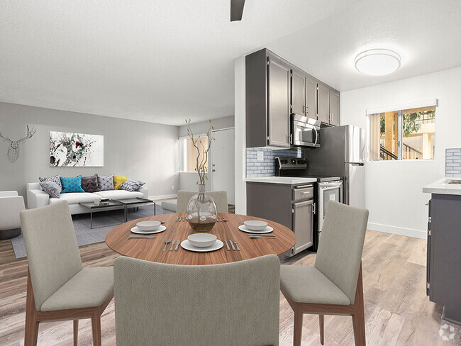 Dining room with hardwood floor and view of living room and tiled and stainless steel kitchen. - Riverbridge Apartments