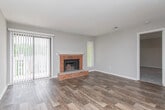 Located at 528 Magnolia Dr in Pine Lake, Georgia, this single-floor residence offers a clean, functional layout with a neutral color palette throughout. The open-concept living and dining area is finished with durable wood-look flooring, allowing natural light to flow through large windows fitted with vertical blinds. A textured ceiling adds a classic touch to the shared living spaces.

The kitchen is well-appointed with dark espresso cabinetry, stone-look countertops, a tile backsplash, and a full suite of black appliances including a refrigerator, electric range, dishwasher, and microwave. A pantry with louvered doors provides convenient additional storage.

The bedrooms feature plush carpeting and neutral warm-toned walls, offering comfortable, versatile spaces. Each room is outfitted with multiple electrical outlets and ample wall space.

Two bathrooms serve the residence, each featuring dark wood vanity cabinetry, speckled stone-look countertops, large wall mirrors, brushed nickel fixtures, and towel bars. One bathroom includes a shower/tub combination with white tile surround, while the other provides access to a walk-in closet. Wood-look flooring extends into the bathrooms, maintaining a cohesive aesthetic. Overall, the space presents a move-in ready environment with practical finishes throughout.