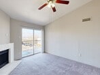Located at 7000 Cook Rd in Houston, TX, this three-bedroom, one-bathroom residence offers a thoughtfully arranged single-floor layout with a comfortable sense of scale throughout. The living room serves as the heart of the home, featuring vaulted ceilings, soft carpeting, a ceiling fan with light fixture, and a charming white brick fireplace. A sliding glass door opens directly onto the balcony, filling the space with natural light and providing outdoor views. The kitchen is efficiently designed with white cabinetry, stainless steel appliances including a range and refrigerator, and a peninsula counter that connects to the dining area. Light wood-style flooring runs through the kitchen and dining space, offering a clean contrast to the carpeted living and bedroom areas. The spacious primary bedroom features a bay window, ceiling fan, and abundant natural light. The two additional bedrooms are well-proportioned, each with ceiling fans and generous closet access — the unit includes five closets in total. The full bathroom offers a tub/shower combination. A dedicated laundry area and a welcoming entrance complete this functional and comfortable home.