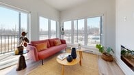 Located at 20 Rue De La Bonne Renomée in Gatineau, Quebec, this well-designed 2-bedroom, 1-bathroom residence offers a contemporary layout across a single floor. The open-concept kitchen and living area serves as the heart of the home, where light hardwood flooring, white cabinetry, a wood-accented island, and stainless steel appliances create a clean, modern aesthetic. Pendant lighting adds a refined touch above the countertops. The living room is bathed in natural light from a wall of large windows overlooking the balcony and surrounding landscape. A sleek, wall-mounted fireplace anchors the space with warmth and character. The primary bedroom features a generous window with scenic outdoor views, providing a bright and serene retreat. The second bedroom offers a built-in double closet and soft natural light. The hallway entrance is accented by bold artwork, setting an artistic tone from the moment you step inside. The full bathroom is elegantly appointed with a glass-enclosed shower, a deep soaking tub, wood-toned cabinetry, and tile flooring. A dedicated closet and hallway complete the functional layout of this thoughtfully designed home.