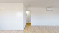 Located in South Pasadena, CA, this well-appointed 2-bedroom, 1-bathroom unit offers a clean, modern aesthetic throughout its thoughtfully designed single-floor layout. Light wood vinyl flooring flows seamlessly through every room, creating a warm and cohesive feel that complements the bright white walls and contemporary finishes.

The open kitchen and living area serves as the heart of the unit, featuring dark navy shaker-style cabinetry with gold hardware, crisp white quartz countertops, a deep stainless steel sink with a matte black industrial-style faucet, and stainless steel appliances including a refrigerator, range, and dishwasher. A wall-mounted range hood and floating wood shelves add both function and style.

Both bedrooms are comfortably sized, filled with natural light through large windows fitted with layered privacy blinds. Each bedroom includes a sliding-door closet, providing ample storage. The primary bedroom features a wall-mounted mini-split unit for individual climate control, while built-in shelving in one bedroom adds extra utility.

The bathroom is finished with large-format white subway tile in the shower/tub combo, matte black fixtures, a built-in niche, and hexagonal floor tile — delivering a clean, contemporary look. A connecting hallway ties the unit together efficiently, completing a practical and polished living space.