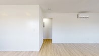 Located in South Pasadena, CA, this well-appointed 2-bedroom, 1-bathroom unit offers a clean, modern aesthetic throughout its thoughtfully designed single-floor layout. Light wood vinyl flooring flows seamlessly through every room, creating a warm and cohesive feel that complements the bright white walls and contemporary finishes.

The open kitchen and living area serves as the heart of the unit, featuring dark navy shaker-style cabinetry with gold hardware, crisp white quartz countertops, a deep stainless steel sink with a matte black industrial-style faucet, and stainless steel appliances including a refrigerator, range, and dishwasher. A wall-mounted range hood and floating wood shelves add both function and style.

Both bedrooms are comfortably sized, filled with natural light through large windows fitted with layered privacy blinds. Each bedroom includes a sliding-door closet, providing ample storage. The primary bedroom features a wall-mounted mini-split unit for individual climate control, while built-in shelving in one bedroom adds extra utility.

The bathroom is finished with large-format white subway tile in the shower/tub combo, matte black fixtures, a built-in niche, and hexagonal floor tile — delivering a clean, contemporary look. A connecting hallway ties the unit together efficiently, completing a practical and polished living space.