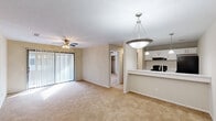 This single-floor, 3-bedroom, 1-bathroom home in Columbus, Georgia offers a practical and comfortable layout with a warm, neutral aesthetic throughout. The open-concept living area is bright and welcoming, featuring plush wall-to-wall carpeting, a ceiling fan with light, and large sliding glass doors dressed with vertical blinds that fill the space with natural light. The kitchen flows seamlessly from the living area via a peninsula counter finished with a light granite-style surface and served by pendant lighting overhead. White cabinetry, black appliances including a refrigerator and range, and an under-cabinet range hood give the kitchen a clean, functional appearance. An adjacent pantry provides additional storage. The primary bedroom is generously sized with carpet flooring, a ceiling fan, and direct access to a closet and the bathroom. The bathroom features a wide vanity with granite-style countertops, white cabinetry, wood-look flooring, and a separate water closet. Two additional bedrooms each include carpet flooring, ceiling fans, and windows that allow natural light. Each bedroom offers closet storage, with bifold doors providing easy access. A hallway connects the bedrooms and common areas, completing this well-organized, move-in-ready home.