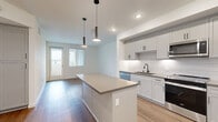 Located at 6000 Luminary Drive in Chula Vista, CA, this well-designed 2-bedroom, 1-bathroom home offers a thoughtfully laid-out single-floor plan with modern finishes throughout. The open-concept living area seamlessly connects the kitchen, dining, and living spaces, creating an inviting and functional environment. The kitchen is a standout feature, equipped with white shaker-style cabinetry, a white subway tile backsplash, stainless steel appliances including a refrigerator, range, dishwasher, and microwave, as well as a central island with pendant lighting overhead — ideal for meal prep and casual dining. Light wood-tone flooring runs throughout the main living area, complementing the clean, neutral color palette. The spacious primary bedroom features a ceiling fan, a large window with outdoor views, and ample natural light. The second bedroom is bright and versatile with clean white walls and matching flooring. A well-appointed hallway connects the bedrooms to the full bathroom, which includes a tiled shower/tub combo, a vanity with a quartz-style countertop, and warm wood-tone flooring. Additional conveniences include a dedicated laundry area, a closet, and a private balcony, rounding out this modern and efficient home.
