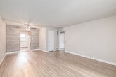Located at 1821 N Pacific Coast Hwy in the sought-after coastal community of Hermosa Beach, California, this 2-bedroom, 3-bathroom single-floor unit offers a functional and well-appointed layout. The living room features wood-look plank flooring, neutral toned walls, a textured ceiling with a ceiling fan, and a large window with vertical blinds that invites natural light into the space. The entry area incorporates a tasteful tile inlay that transitions seamlessly into the main living area. Both bedrooms continue the warm wood-look flooring, with the primary bedroom offering a wall of mirrored sliding closet doors that enhance the sense of space, alongside multi-pane windows for natural light. The second bedroom is a comfortable, quiet space with its own door access. The galley-style kitchen is equipped with warm honey-toned cabinetry, a mosaic tile backsplash, light countertops, tile flooring, and a full suite of appliances, with a window and exterior door providing added ventilation. The three bathrooms feature light tile flooring, white vanity cabinetry, and well-lit mirrors. A dedicated hallway and closet round out the thoughtful layout of this Hermosa Beach residence.