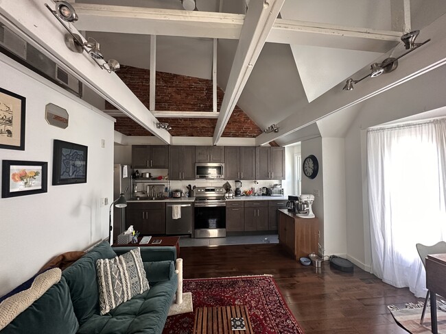 Living & Kitchen area with loft ceiling and exposed brick - 4818-3 Baltimore Ave