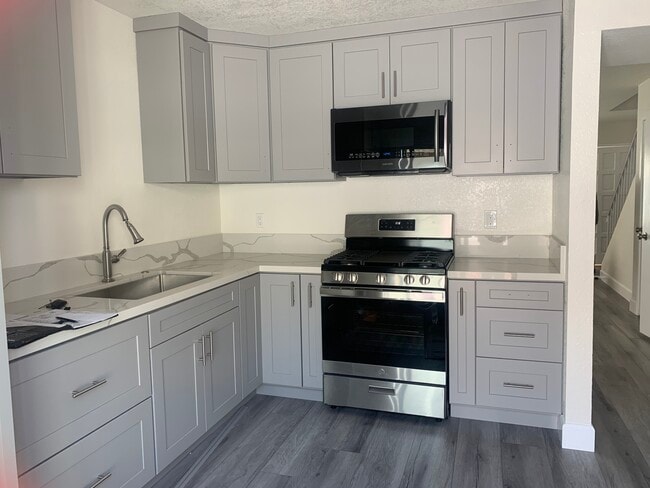 Kitchen w/ stove & microwave - 12836 12th St