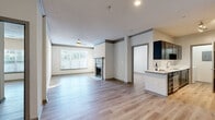 Located at 1200 Reserve Drive Northeast in Atlanta's 30319 zip code, this two-bedroom, two-bathroom residence offers a well-designed single-level layout with a cohesive, modern aesthetic throughout. Light-toned hardwood-style flooring runs continuously across every room, lending a sense of openness and consistency to the entire space.

The living room serves as the heart of the home, anchored by a classic fireplace and framed by a large window that draws in abundant natural light. A ceiling fan adds comfort, while crown molding details lend a polished finish. The adjoining kitchen is appointed with dark cabinetry, stainless steel appliances, white quartz countertops, and a mosaic tile backsplash, offering both style and functionality in a well-organized galley-style layout.

The primary bedroom is a comfortable, sunlit retreat with a ceiling fan and a sizable walk-in closet outfitted with wire shelving for ample storage. The second bedroom is equally bright, featuring a large window with outdoor views. Both bathrooms include dark-framed vanities with white countertops, tub-shower combinations, and light flooring.

Additional highlights include a dedicated in-unit laundry area and a welcoming entryway that opens into the main living space. The overall ambiance is clean, contemporary, and move-in ready.