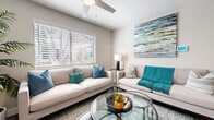 Located at 7007 W Indian School in Phoenix, Arizona, this single-floor residence offers a well-appointed layout designed for comfortable everyday living. The living area serves as the heart of the home, featuring warm neutral tones, light wood-style flooring, and large windows dressed with horizontal blinds that invite generous natural light. A ceiling fan overhead and a striking abstract canvas in teal and blue hues add character to the space, which is anchored by a circular glass-top coffee table.

The kitchen is outfitted with crisp white shaker cabinetry, a classic subway tile backsplash, stainless steel appliances including a refrigerator, dishwasher, and range, and a built-in microwave. Track lighting illuminates the workspace, and a conveniently tucked laundry area with a washer is accessible directly from the kitchen.

The primary bedroom features light wood-style flooring, a ceiling fan, a sliding closet, and a decorative medallion wall accent above the bed, creating a calm and restful atmosphere. A second bedroom offers similarly serene finishes, with neutral walls, wood-style flooring, and a window that brings in soft natural light. A spacious walk-in or reach-in closet with sliding doors provides ample storage. Clean hallways connect each area of the home, completing a cohesive and functional floor plan.