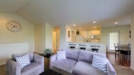 Located at 3900 Suffolk Dr in Dublin, Ohio, this single-floor home offers a thoughtfully designed open-concept layout that seamlessly connects the main living spaces. The living room is a standout feature, boasting soaring vaulted ceilings that amplify the sense of space and airiness. Multiple windows dressed with patterned curtains invite abundant natural light throughout the day, while a tile-surround fireplace serves as a warm focal point for the room. The space comfortably accommodates generous seating arrangements and opens to a view of the adjoining areas. The kitchen is efficiently designed with white cabinetry, recessed lighting, and includes a breakfast bar with bar stool seating — ideal for casual dining or entertaining. The pass-through design between the kitchen and living area enhances the open feel of the home. Neutral tones and soft finishes run throughout, creating a clean and inviting ambiance. The layout flows naturally between spaces, making the home feel both functional and welcoming. With its combination of vaulted ceilings, natural light, open-plan living, and classic design elements, this Dublin home delivers a comfortable and well-appointed single-level living experience.