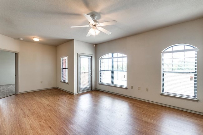 Living room and door to the patio/balcony at Bradford Place Apartments - Bradford Place Apartments