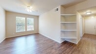 Located at 5400 Sycamore School Rd in Fort Worth, TX, this single-story, three-bedroom, two-bathroom home offers a well-organized layout across a comfortable footprint. Wood-look flooring flows throughout the living areas and bedrooms, lending warmth and visual continuity to the space.

The kitchen is equipped with warm oak cabinetry, granite-style countertops, black appliances including a refrigerator and range, and a stainless steel sink. A built-in breakfast bar provides additional counter space and casual dining potential.

Each of the three bedrooms features ceiling fans and windows that invite natural light and outdoor views. The spacious primary bedroom includes a double-door closet alongside additional built-in shelving, offering generous storage. A separate room features a built-in corner shelving unit, ideal for display or organization.

Both bathrooms are finished with tiled tub-and-shower combos accented by a neutral beige tile border, presenting a clean and classic look. A dedicated laundry room includes washer and dryer hookups — both electric and gas — along with an overhead wire shelf for added utility.

The home also features a hallway nook with a granite-top built-in desk and adjacent open shelving, adding a practical and versatile touch to the overall floor plan.