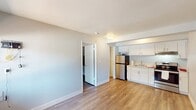 This 340 square foot apartment in Las Vegas offers a well-designed living space within a compact footprint. The single-floor layout comprises one bedroom, one bathroom, and a kitchen, efficiently utilizing every inch of space.

The bedroom, measuring 110 square feet, features wood-look flooring and a built-in closet with a hanging rod, providing ample storage. A window allows natural light to brighten the space, creating an airy atmosphere.

The bathroom is equipped with modern fixtures, including a full-sized bathtub with shower, a standard toilet, and vanity storage. Attention to detail is evident in the coordinated towels and bath mat, enhancing the overall aesthetic.

The kitchen showcases a contemporary design with white cabinetry, stainless steel appliances, and a sleek range hood. The layout includes a refrigerator, oven, and sink, all arranged for maximum functionality in the limited space.

Throughout the apartment, wood-look flooring creates a cohesive and modern appearance. The neutral color palette, predominantly featuring white walls, contributes to a sense of spaciousness and allows for personalization.

While compact, this apartment offers a comfortable living environment, ideal for singles or couples seeking an efficient urban dwelling in Las Vegas.