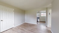 Located at 7495 N Lowell Blvd in Westminster, Colorado, this single-floor unit offers a clean, modern aesthetic with thoughtful updates throughout. The open living area is finished with light wood-style flooring and neutral-toned walls, creating a bright and welcoming atmosphere. Natural light filters in through multiple windows, enhancing the airy feel of the space.

The kitchen is a standout feature, outfitted with white cabinetry, dark granite-style countertops, and a classic white subway tile backsplash. Stainless steel appliances — including a range, dishwasher, and refrigerator — complete the functional and stylish cooking space. A double basin sink sits beneath a window overlooking the outdoors.

The bedroom offers plush carpeting and dual windows that invite generous natural light and outdoor views of the surrounding neighborhood. Baseboard heating is present throughout the unit, ensuring consistent comfort year-round.

The bathroom is finished with crisp white subway tile surrounding a full soaking tub and shower, complemented by brushed nickel fixtures and tile flooring — a clean, classic design. The entry area provides convenient closet storage and connects seamlessly to the main living spaces, making the layout practical and easy to navigate.