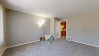 Located in Hopkins, Minnesota, this two-bedroom, one-bathroom residence is spread across three floors, offering a practical and comfortable layout. The entry-level living room greets you with neutral-toned carpet, soft gray walls, and a window fitted with vertical blinds that frame outdoor views of mature trees, filling the space with natural light. The adjacent kitchen is well-appointed with warm oak cabinetry, white countertops, a tile backsplash, and light wood-style flooring. It includes a black electric range, stainless steel dishwasher, and a full-size refrigerator, making it both functional and inviting. A dedicated dining or entry area features the same light flooring, a window for added brightness, and direct access to the exterior door. The two bedrooms are carpeted and finished with neutral walls; the primary bedroom features a ceiling fan with light fixture and a window with outdoor views, while the secondary bedroom is compact and bright with natural light. The full bathroom is finished with tile flooring, a white vanity, and a shower-tub combination. A utility room, hallway, closet, and two staircases complete the multi-level floor plan, providing ample storage and connectivity throughout this well-maintained Hopkins home.