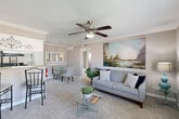 Located at 8181 Colony Dr in Houston, TX, this well-appointed single-floor, one-bedroom, one-bathroom residence offers a thoughtfully designed layout across a compact yet efficient footprint. The open-concept living and dining area serves as the heart of the home, featuring plush carpeting, crown molding, and a ceiling fan that enhances both comfort and style. A large landscape painting anchors the living space, while a pass-through counter connects seamlessly to the kitchen, creating an inviting, social atmosphere.

The kitchen is equipped with black appliances, including an electric range and refrigerator, complemented by white cabinetry and a granite-style countertop. Wood-look flooring in the kitchen adds a clean contrast to the carpeted living areas. A dedicated dining space with pendant lighting provides a comfortable setting for everyday meals.

The bedroom is a serene retreat, featuring carpeted floors, a teal accent wall, and a window that allows natural light to filter in. Three closets throughout the unit — including a spacious walk-in — offer generous storage. The bathroom includes a tub-shower combination with marble-style tile surround and a granite-style vanity countertop. A hallway and entrance area complete this efficiently organized and well-finished residence.