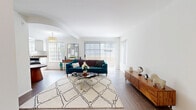 Located in North Hollywood, this single-story, 3-bedroom, 2-bathroom home offers a well-organized layout across one level. The living room is bright and welcoming, featuring wood-style flooring, large sliding glass doors with vertical blinds that invite abundant natural light, and a fireplace that serves as a focal point. The galley-style kitchen is well-appointed with white cabinetry, dark countertops, stainless steel appliances including a gas range and dishwasher, and a tray ceiling with overhead lighting. A dining area sits adjacent, bathed in natural light from surrounding windows. The spacious primary bedroom features plush carpeting and a dedicated window for natural light, offering a comfortable and restful retreat. The two additional bedrooms are equally carpeted, with one featuring mirrored sliding closet doors that enhance the sense of space. Both bathrooms are finished with clean white fixtures, wood-style flooring, and sliding glass shower enclosures over tub-shower combos. A hallway connects the bedrooms and bathrooms, providing a logical and efficient flow throughout the home. The overall aesthetic is clean, bright, and functional, with a neutral palette throughout.