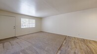 Located at 350 N Harrison Rd in Tucson, Arizona, this single-story, 2-bedroom, 1-bathroom home offers a functional and efficiently designed layout. The combined kitchen and living area serves as the heart of the home, where wood-look tile flooring flows through the living space alongside plush carpeting, creating a comfortable and practical environment. A ceiling fan with a built-in light fixture provides both ventilation and ambient lighting, while a window with vertical blinds allows natural light to filter in. A pass-through counter connects the living area to the kitchen, enhancing the open feel.

The galley-style kitchen is well-appointed with white cabinetry, light quartz-style countertops, a stainless steel sink, and white appliances including an electric range, refrigerator, and dishwasher. Wood-look tile flooring and overhead lighting complete the clean, bright aesthetic.

Both bedrooms feature neutral carpet, white walls, and ceiling fans with lighting. The primary bedroom offers a generous footprint with a window providing natural light and outdoor views. The full bathroom includes a tub/shower combo with a white surround, wood-look tile flooring, a white vanity with a light countertop, and classic fixtures. A dedicated closet provides additional storage within the home.