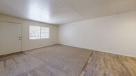 Located at 350 N Harrison Rd in Tucson, Arizona, this single-story, 2-bedroom, 1-bathroom home offers a functional and efficiently designed layout. The combined kitchen and living area serves as the heart of the home, where wood-look tile flooring flows through the living space alongside plush carpeting, creating a comfortable and practical environment. A ceiling fan with a built-in light fixture provides both ventilation and ambient lighting, while a window with vertical blinds allows natural light to filter in. A pass-through counter connects the living area to the kitchen, enhancing the open feel.

The galley-style kitchen is well-appointed with white cabinetry, light quartz-style countertops, a stainless steel sink, and white appliances including an electric range, refrigerator, and dishwasher. Wood-look tile flooring and overhead lighting complete the clean, bright aesthetic.

Both bedrooms feature neutral carpet, white walls, and ceiling fans with lighting. The primary bedroom offers a generous footprint with a window providing natural light and outdoor views. The full bathroom includes a tub/shower combo with a white surround, wood-look tile flooring, a white vanity with a light countertop, and classic fixtures. A dedicated closet provides additional storage within the home.