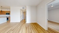 This well-appointed one-bedroom, one-bathroom residence in Sweetwater, FL offers a thoughtfully designed layout with modern finishes throughout. Light wood-tone flooring flows seamlessly across the entire space, creating a warm, cohesive aesthetic.

The open-concept kitchen and living area serves as the heart of the home. The kitchen is outfitted with rich wood-grain cabinetry extending to the ceiling, a quartz countertop island with pendant lighting, stainless steel appliances including a refrigerator and range, and a built-in dishwasher. A matte black faucet and sink add a contemporary accent.

The living area is bright and airy, with a large sliding glass door opening onto a private balcony. From the balcony, residents enjoy open views of the surrounding Sweetwater skyline and palm-lined streetscape beneath South Florida skies.

The bedroom is generously sized, featuring a large window for natural light and direct access to a spacious walk-in closet with built-in shelving and rods for ample storage.

The bathroom is finished with large-format marble-look tile flooring, a dual-sink vanity with quartz countertops and warm wood cabinetry, a full-width mirror, matte black fixtures, and a separate walk-in shower with marble tile surround.